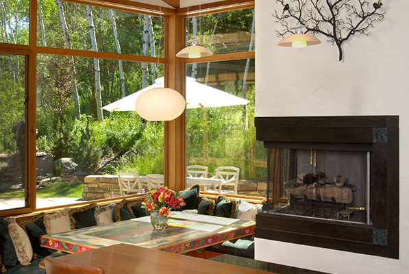 Natural, modern custom home, chairs by Lee Johnson; table by a company called Stix located in Iowa locally represented by Wild Hands Gallery; on the chimney is a swedish wrought iron wall sculpture